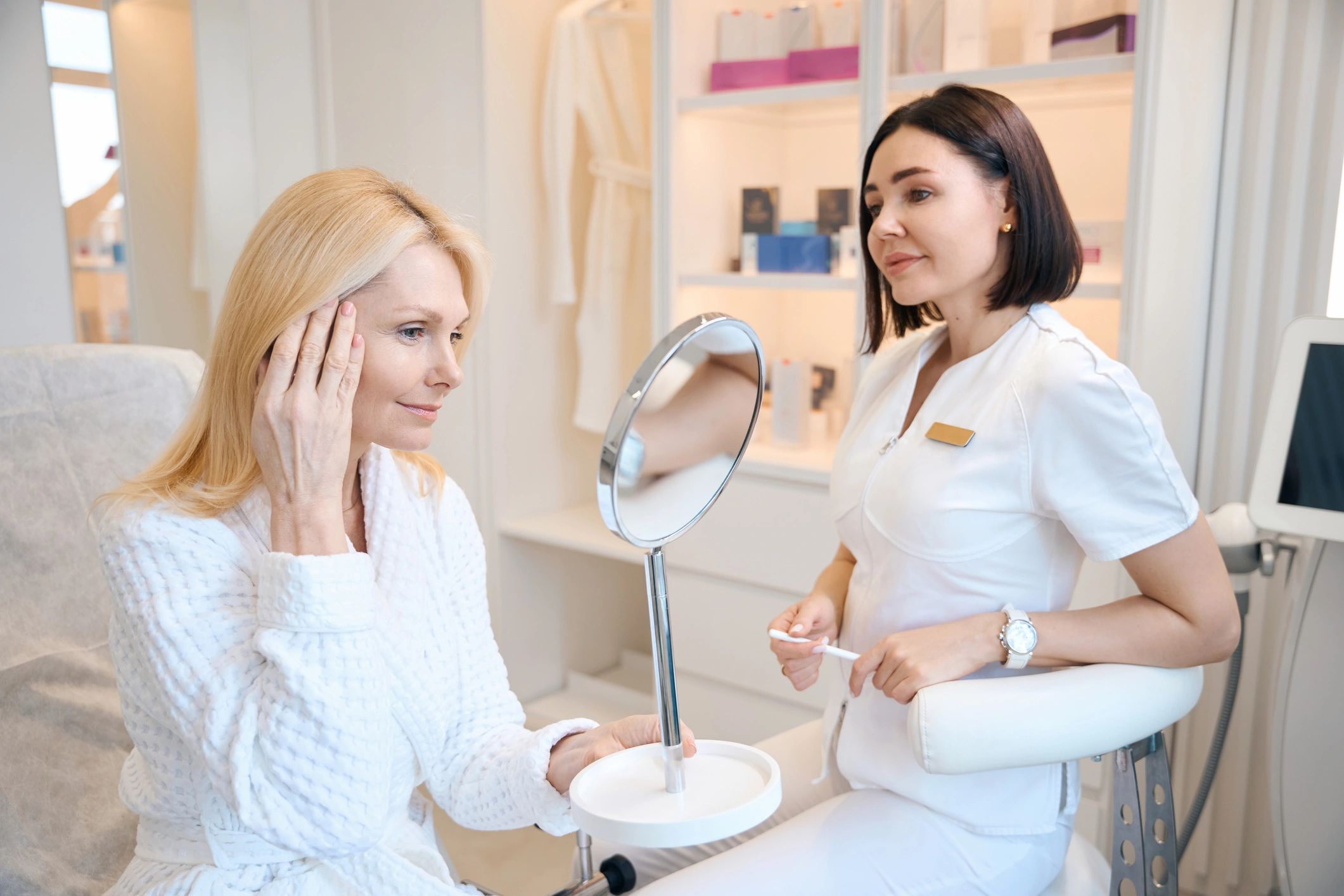 Beautician consulting with a client in a professional skincare office