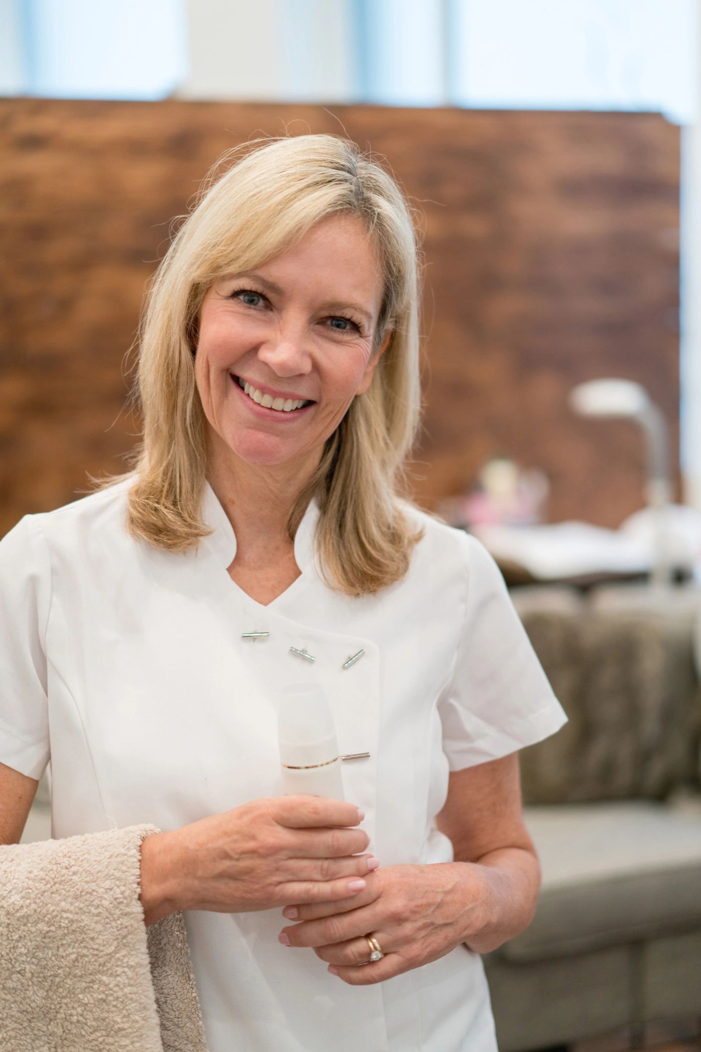 Licensed aesthetician smiling in a spa setting